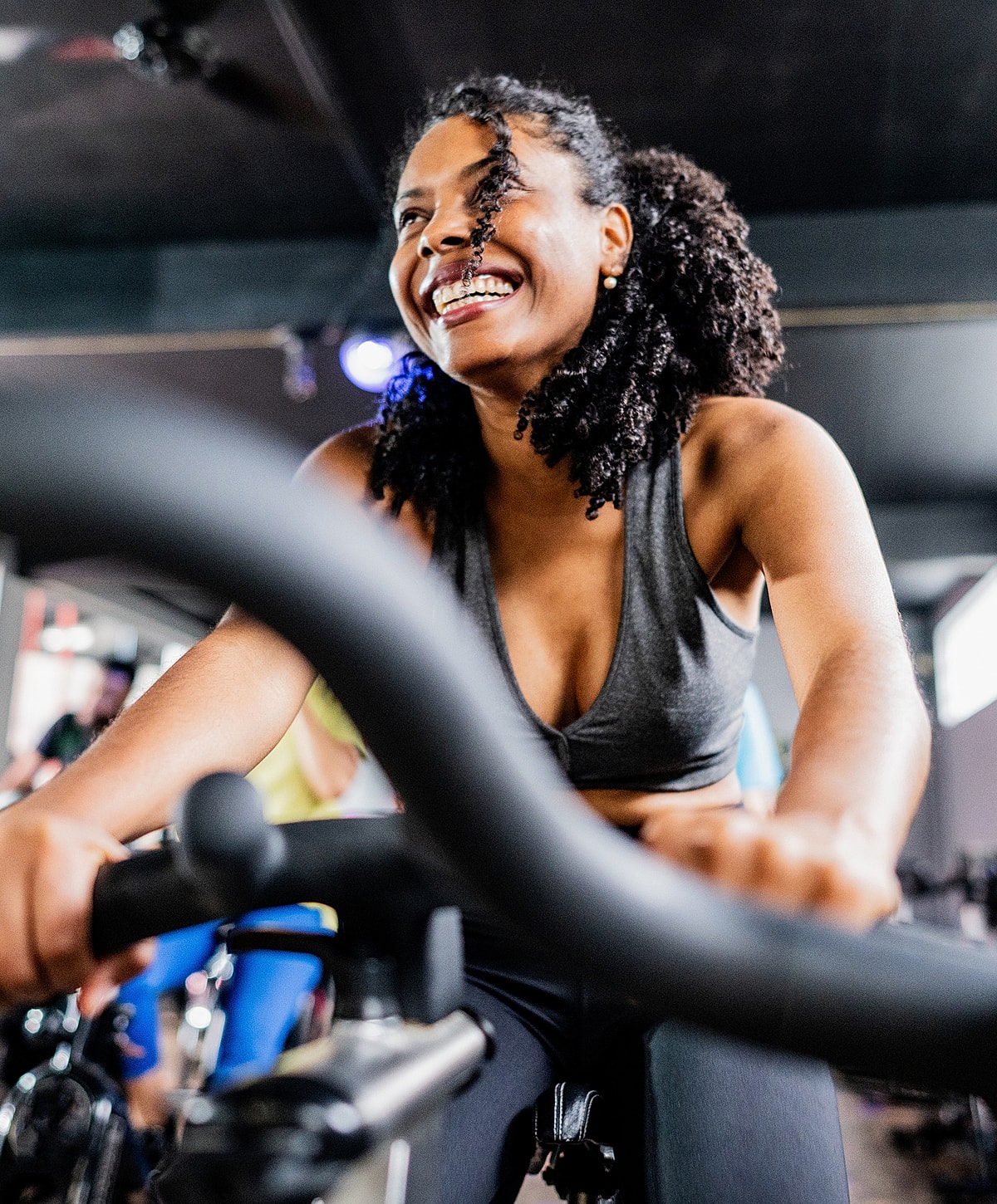 Woman enjoying a spin class workout indoors.