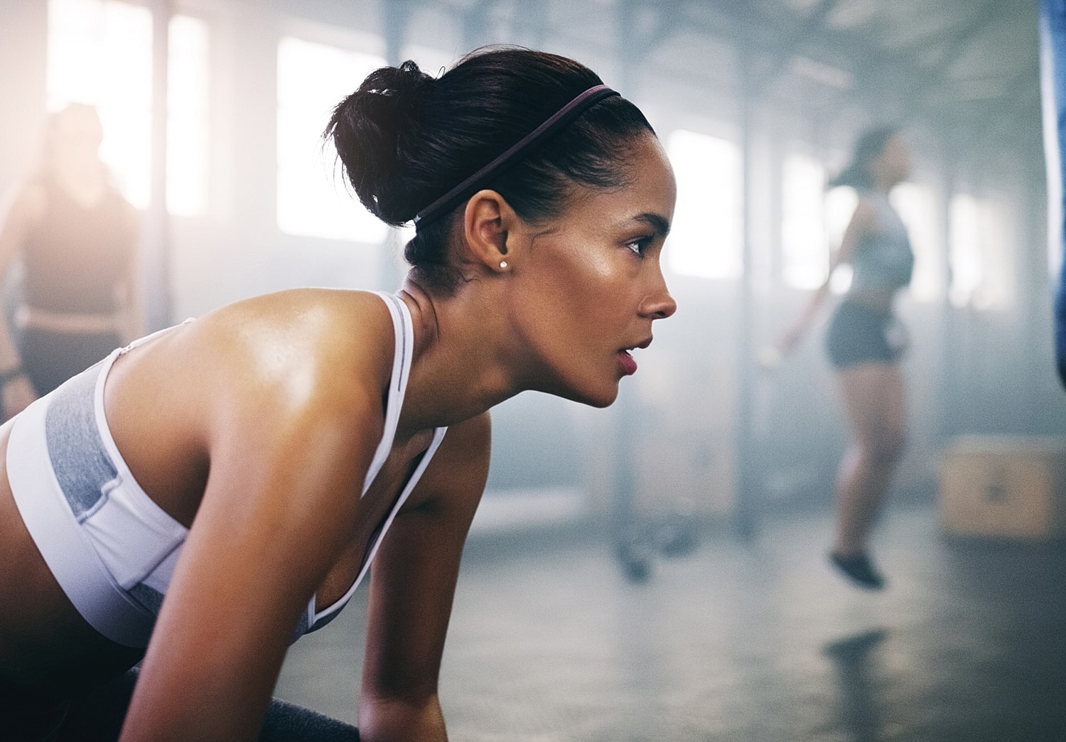 Woman exercising intensely in a fitness studio.