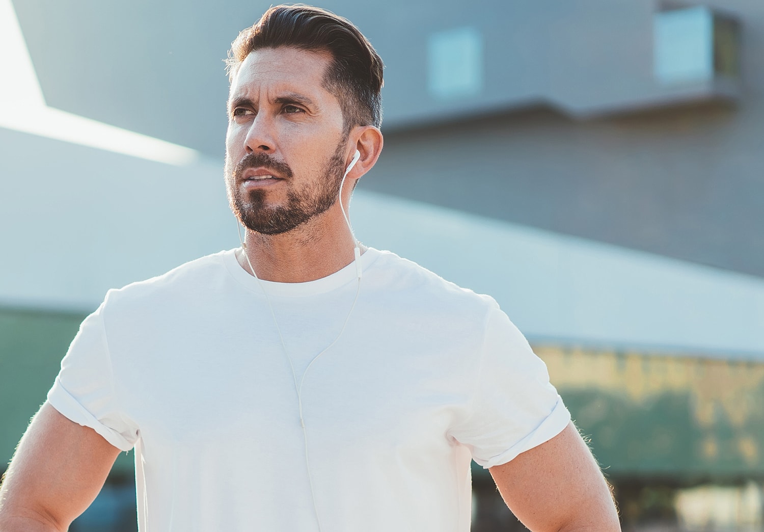 Man listening to music outdoors during daytime.