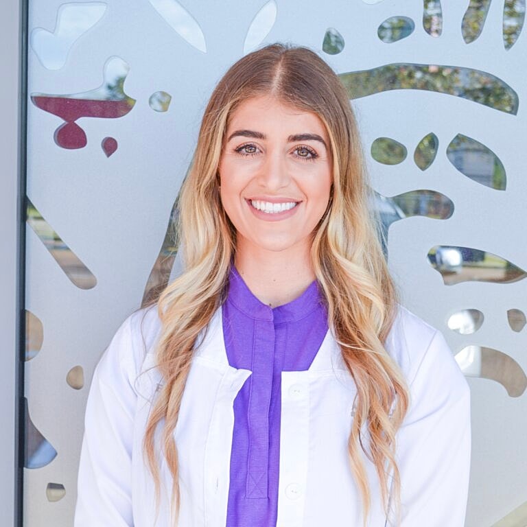 Smiling healthcare professional in white coat.