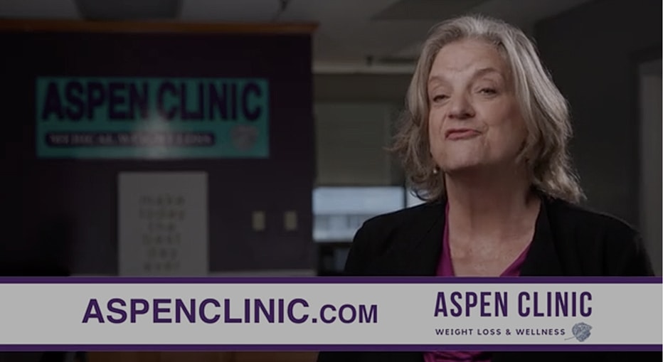 Woman promoting Aspen Clinic services for wellness